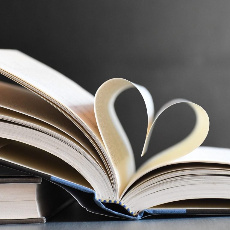 Narrator Services Birmingham, Alabama An open hardcover book with two pages curved together forming a heart to depict narrator services.